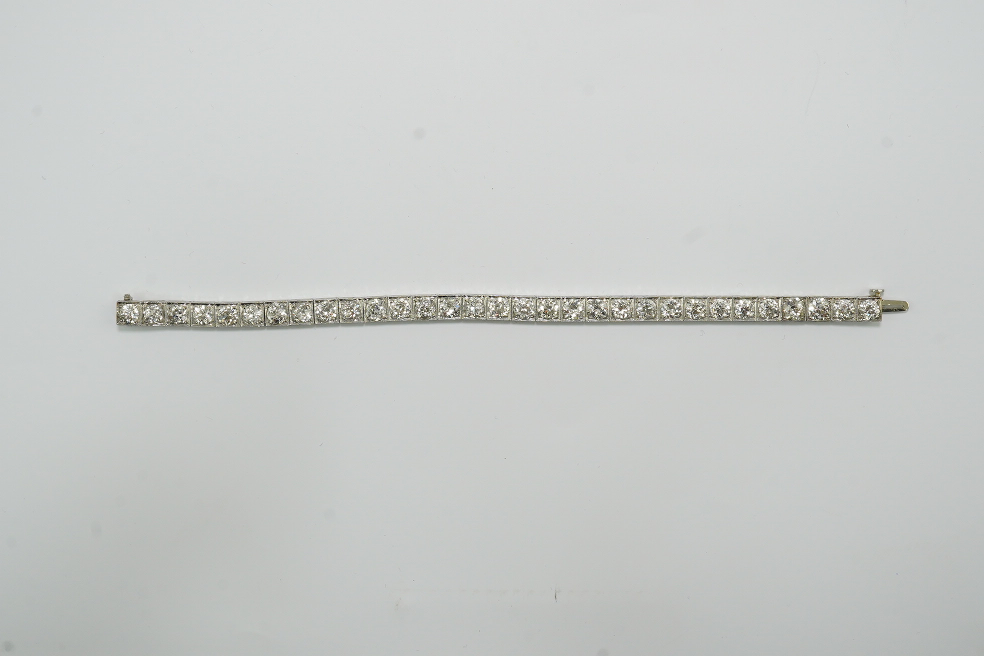 A platinum and thirty one stone round cut diamond set line bracelet